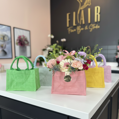 Colorful bags with flowers on a counter in front of a 'Flair' branded wall in Florence, Kentucky