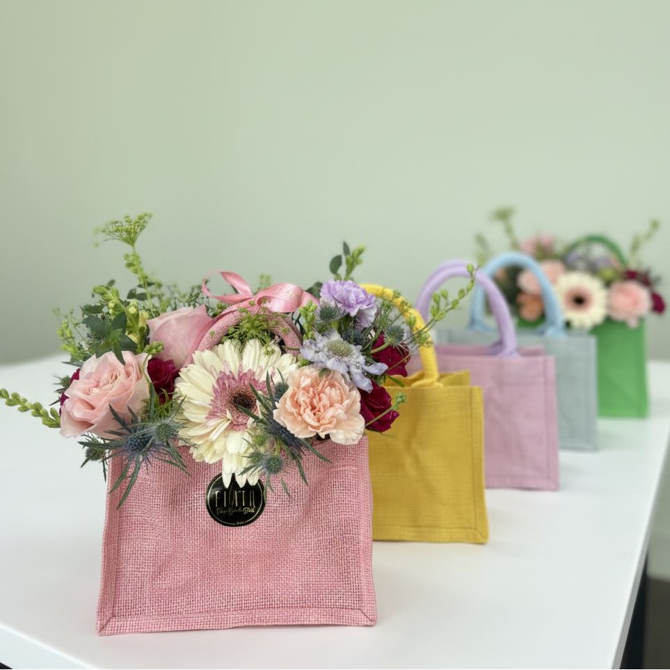  La Petite Tote Arrangement Colorful handbags with floral arrangements on a table, branded 'Flair' in Florence, Kentucky