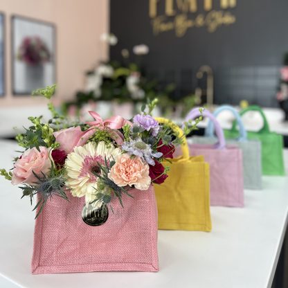  La Petite Tote Arrangement Colorful handbags with floral arrangements on a table, branded 'Flair' in Florence, Kentucky