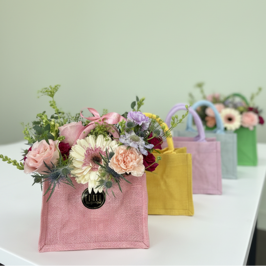  La Petite Tote Arrangement Colorful handbags with floral arrangements on a table, branded 'Flair' in Florence, Kentucky