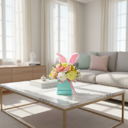 Modern living room with a marble coffee table, flowers, and a sofa.
