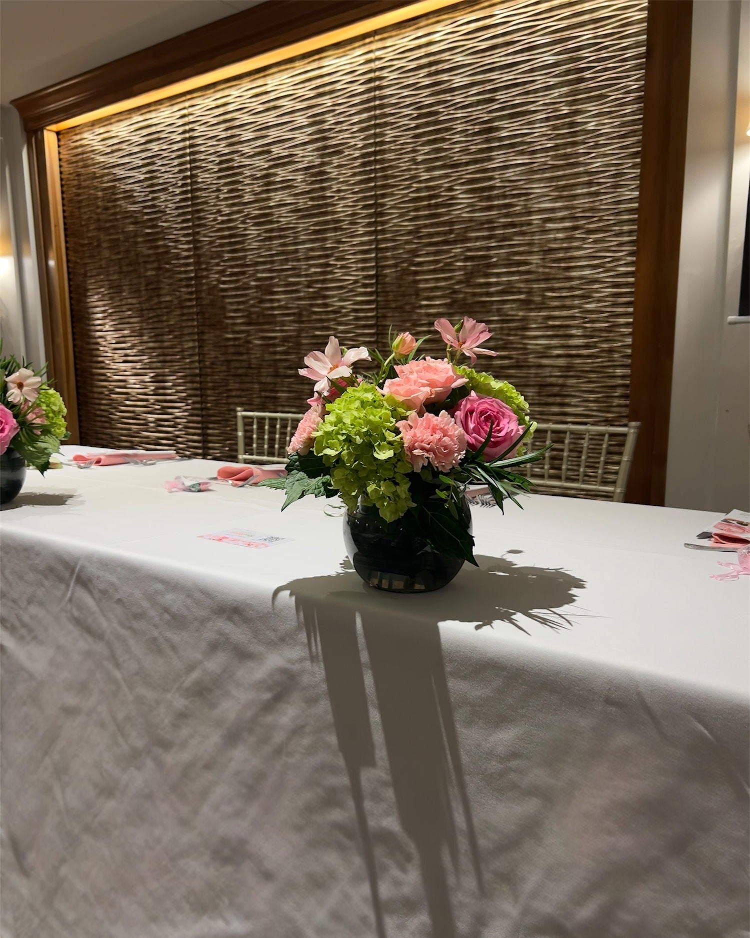 The Madison Event Center, Covington, Kentucky. Floral arrangement on a table with a textured wall in the background. 