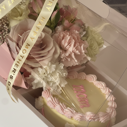 Florence, Kentucky Flower Gift box and cake with pink frosting and 'Happy Mother's Day' ribbon, surrounded by flowers in a box.