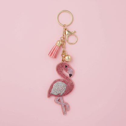 Pink flamingo keychain with gold accents on a pink background