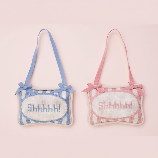 Two decorative pillows with 'Shhhhh!' text on a pink background
