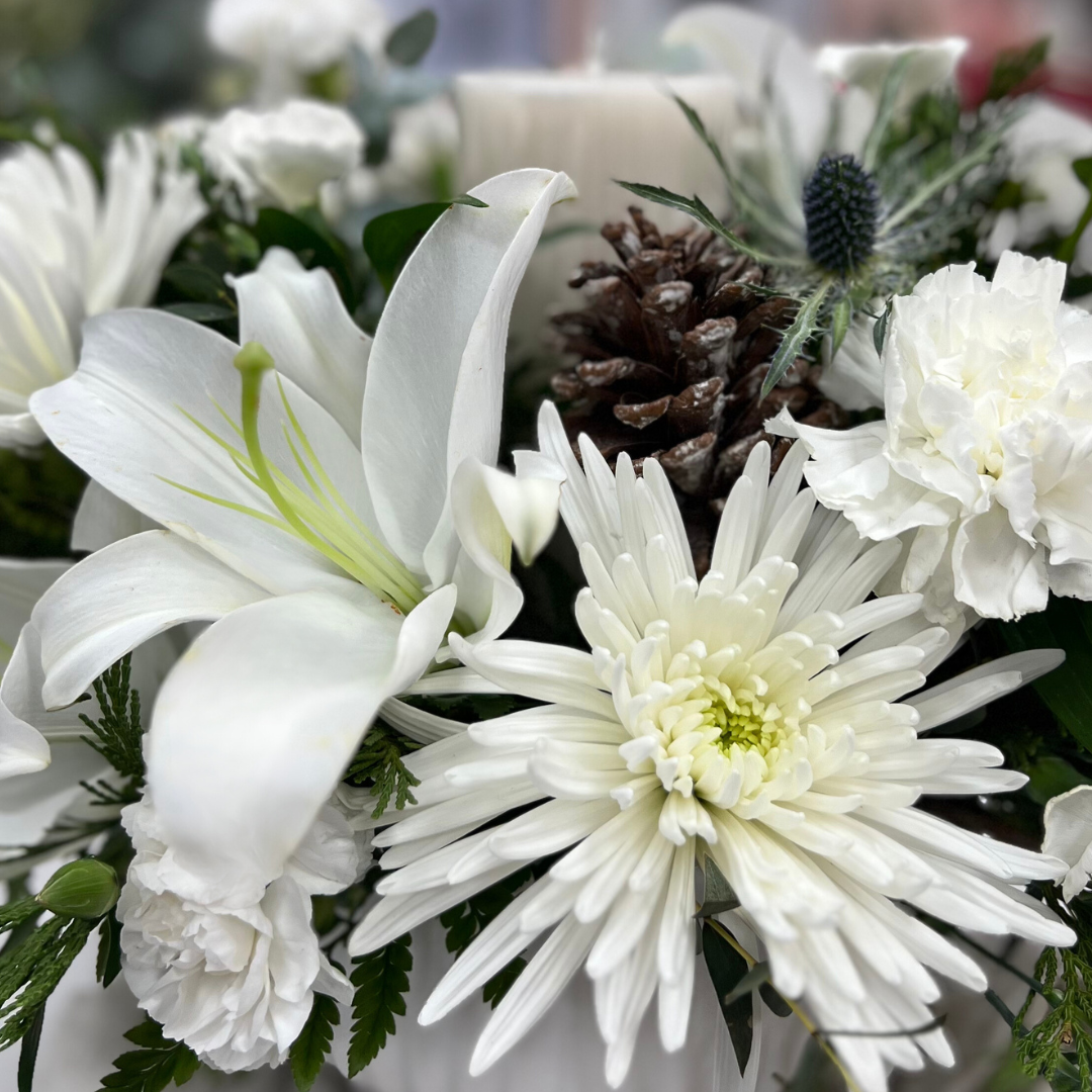 close up of white lily in centerpiece holiday arrangment