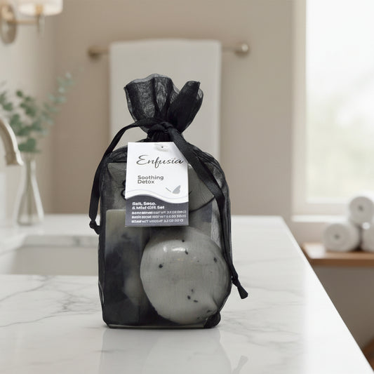 Bath bomb set in a black drawstring bag with a visible label on a white background