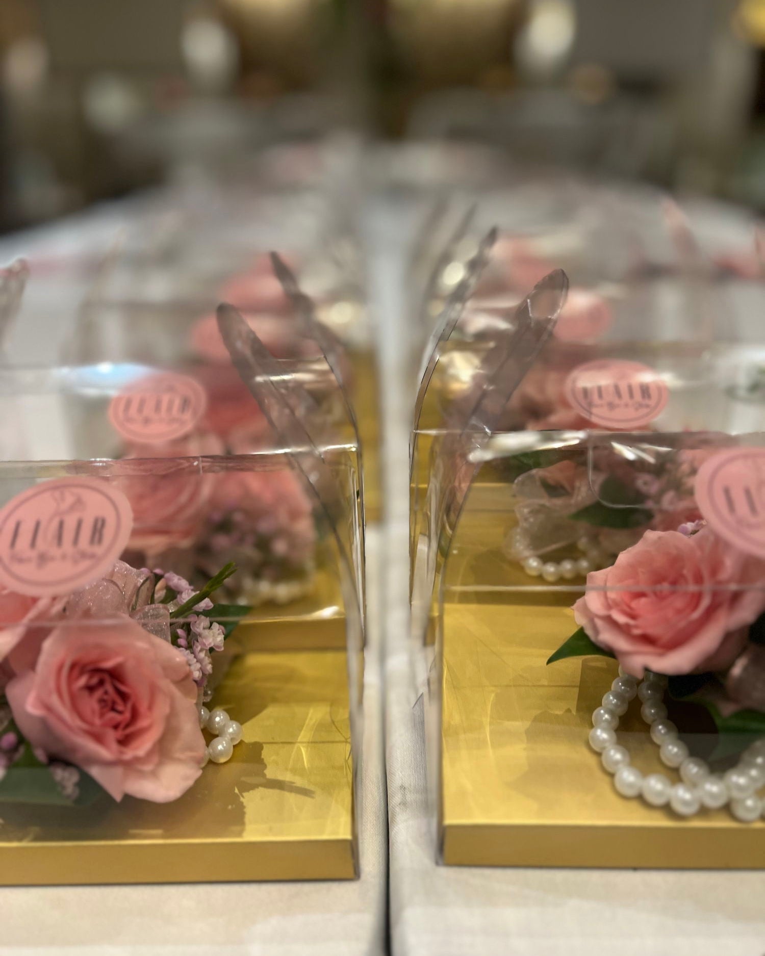 Two clear boxes with pink roses and a pearl corsages.  The Madison Event Center, Covington, Kentucky.