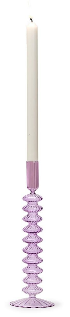 Purple glass candle holder with a white candle on a white background