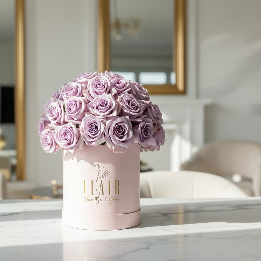 purple roses in pink box with beautiful home background