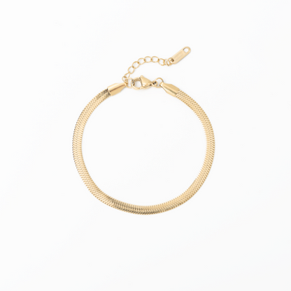 Gold herringbone bracelet on a white background