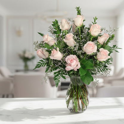 Bouquet of pink roses in a clear vase on a white background